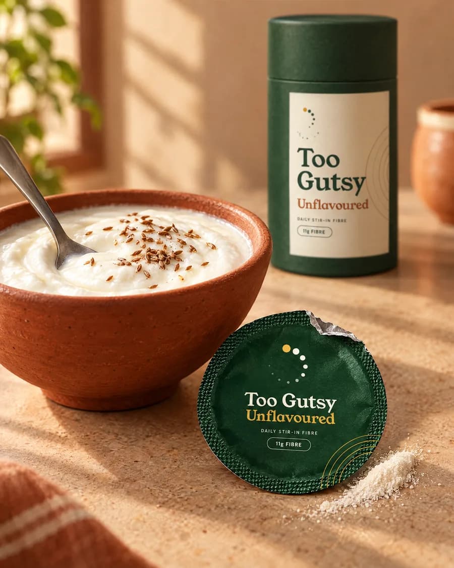 A terracotta bowl of curd beside an opened Unflavoured sachet
